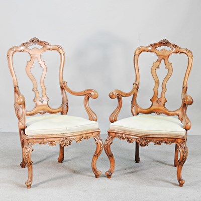 Lot 215 - A pair of Italian carved walnut armchairs, on...