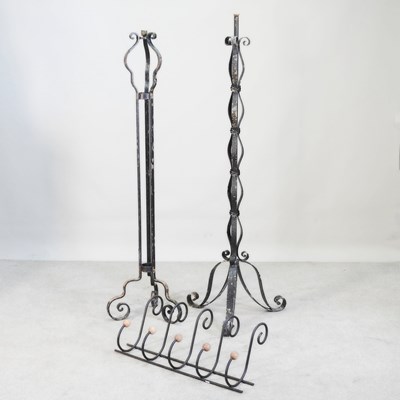 Lot 303 - An iron candlestick, together with another and...