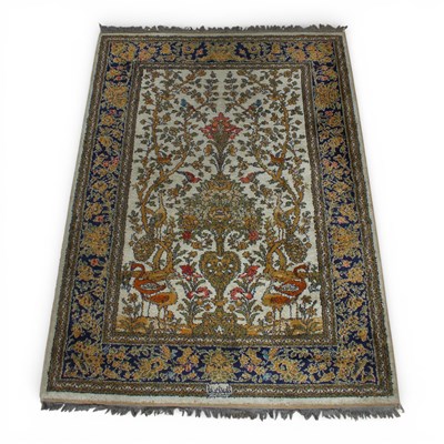 Lot 416 - A Persian silk rug, decorated with a tree of life