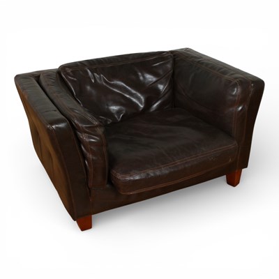 Lot 464 - A brown leather upholstered armchair