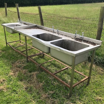 Lot 587 - An industrial stainless triple sink unit