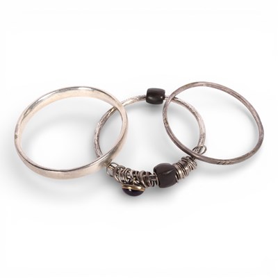 Lot 23 - A collection of three silver bangles, 132g gross