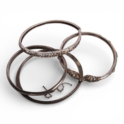 Lot 57 - A collection of four silver bangles, 37g