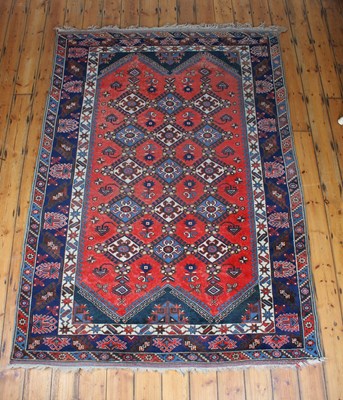 Lot 248 - A mid-20th century Eastern wool rug, red...