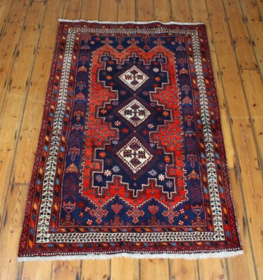 Lot 280 - A 20th century Iranian wool rug, red ground,...