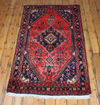 Lot 285 - A 20th century Turkish wool rug, red ground,...