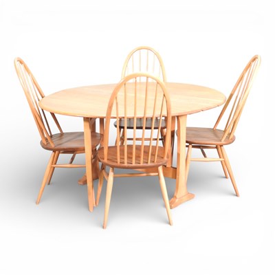 Lot 503 - An Ercol light elm drop leaf circular dining...