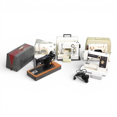 Lot 258 - An electric sewing machine, together with four...