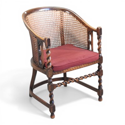 Lot 510 - A 1920s oak bergere armchair, on spirally...