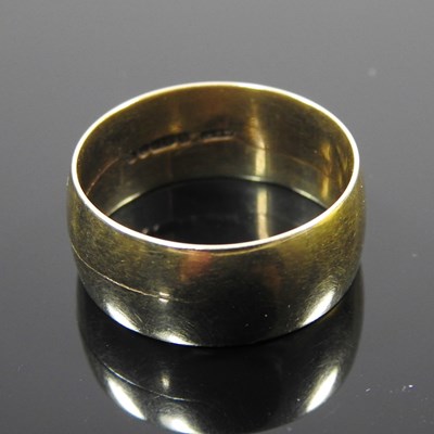 Lot 104 - A 9 carat gold wedding band, of plain design,...