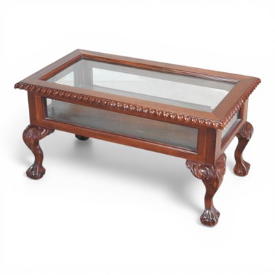Lot 473 - An oriental carved cherrywood glazed coffee...
