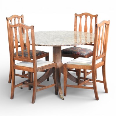 Lot 340 - A granite top circular dining table, on a...