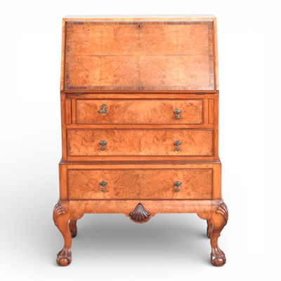 Lot 418 - An early 20th century walnut bureau, on claw...