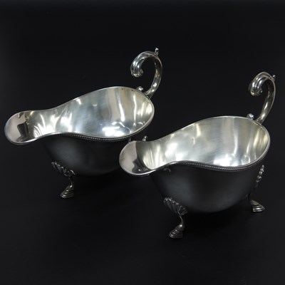 Lot 33 - A pair of early 20th century silver sauce...