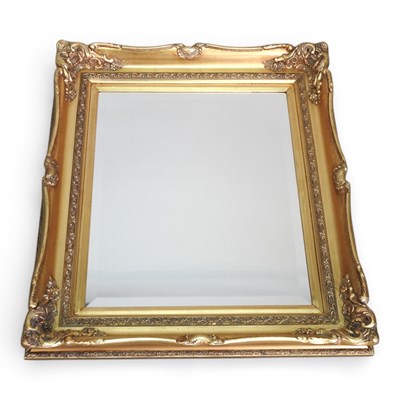 Lot 332 - A modern ornate gilt framed wall mirror, 82 x...