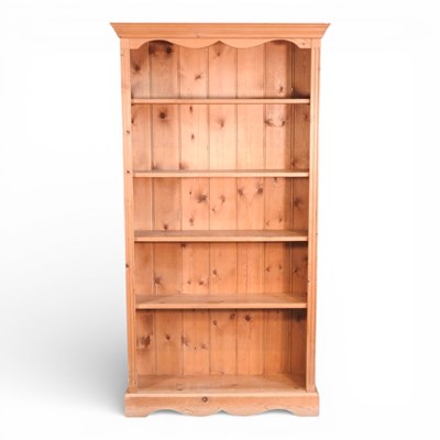 Lot 648 - A modern pine standing open bookcase, on a...