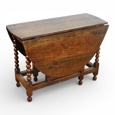 Lot 301 - An antique oak gateleg dining table