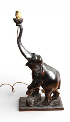 Lot 356 - A carved wood table lamp, in the form of an...