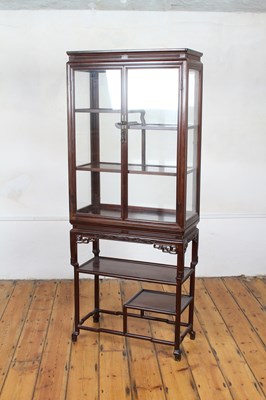 Lot 132 - A Chinese wood display cabinet on a stand, the...