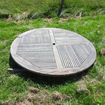 Lot 607 - A teak folding circular garden table