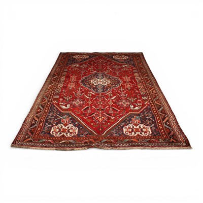 Lot 289 - A Persian red and blue wool rug, the central...