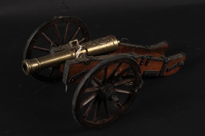 Lot 324 - A brass model Napoleonic cannon, on a wooden...