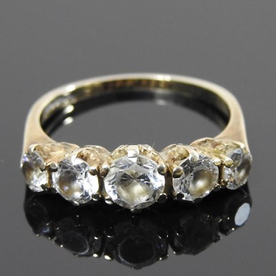 Lot 189a - A gold and gem set ring, set with a row of...