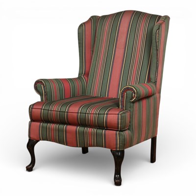 Lot 716 - A striped upholstered wing back armchair, on...