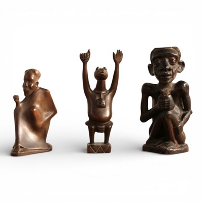 Lot 215 - Three African carved hardwood figures, the...