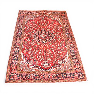 Lot 461 - A Persian Sarouk rug, with foliate designs, on...