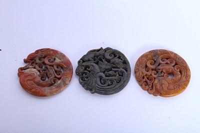 Lot 210 - Three Chinese carved hardstone roundels, w.7cm