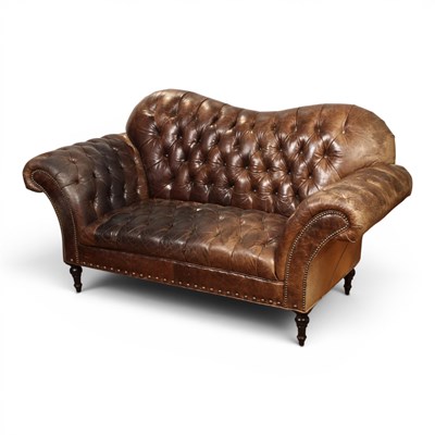 Lot 500 - A brown leather button upholstered...