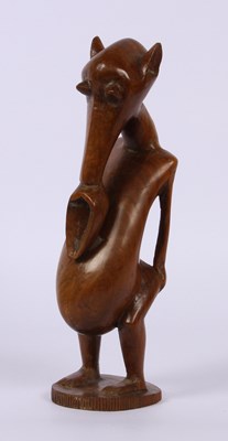 Lot 255 - An African carved hardwood figure, having a...