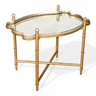 Lot 521 - A gilt metal and mirrored glass side table, 63...