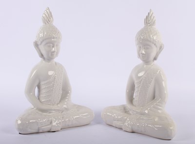 Lot 301 - A pair of white pottery models of Buddha, each...