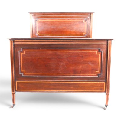 Lot 605 - An Edwardian mahogany bedstead, with satinwood...