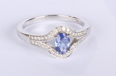 Lot 24 - An 18 carat white gold tanzanite and diamond...