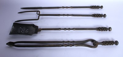 Lot 175 - A collection of wrought iron fire tools, made...