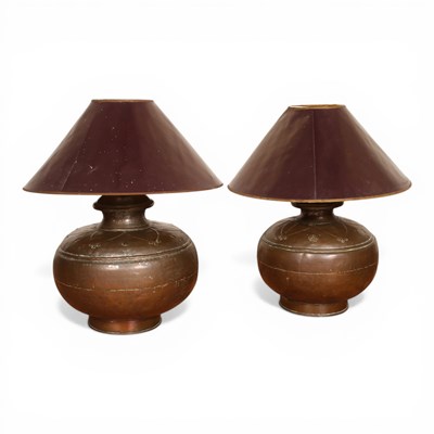 Lot 208 - A pair of hammerbeaten copper table lamps and...
