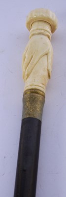 Lot 283 - A carved bone handled walking stick, the...