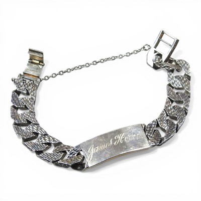 Lot 100 - A 1970s silver gentleman's curb link ID...