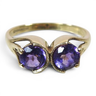 Lot 216 - A 9 carat gold Toi et Moi amethyst bypass ring,...