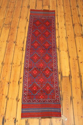 Lot 542 - A Meshwani red runner, 230x60cm.