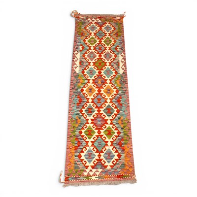 Lot 497 - A Persian kilim runner, with two rows of...