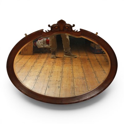 Lot 606 - An early 20th century carved mahogany oval...