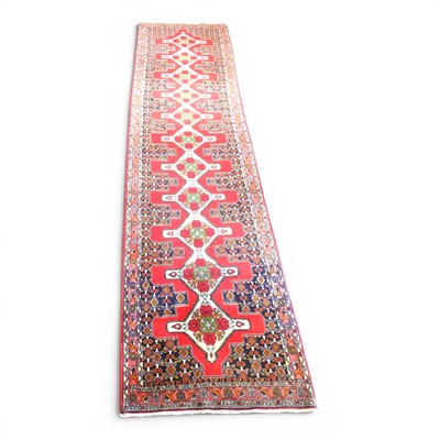Lot 206 - A Persian senneh runner, with a row of central...