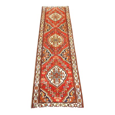 Lot 323 - A Persian Heriz runner, with a central row of...
