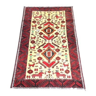 Lot 210 - A Persian Meshed Belouch rug, decorated with...
