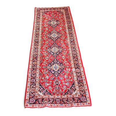 Lot 233 - A Persian Kashan runner, with a central row of...