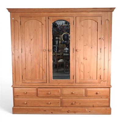 Lot 319 - A large modern pine triple wardrobe, with an...